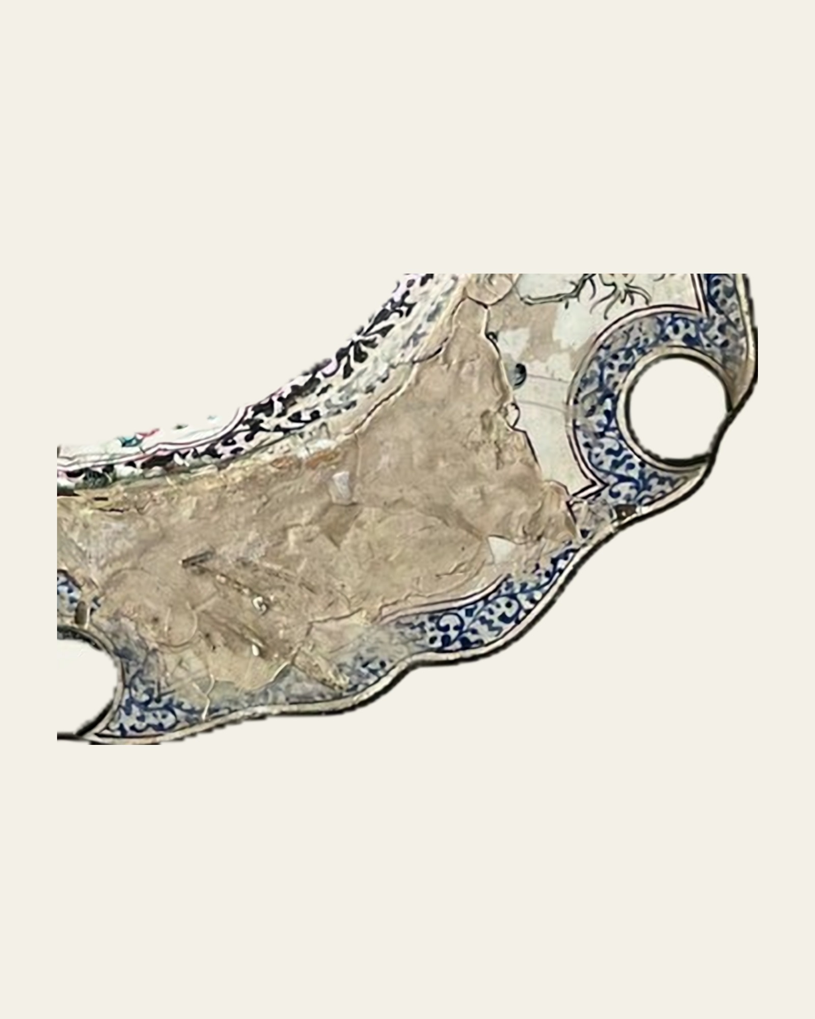 Close-up of a painted enamel surface before treatment, with missing enamel and exposed copper.