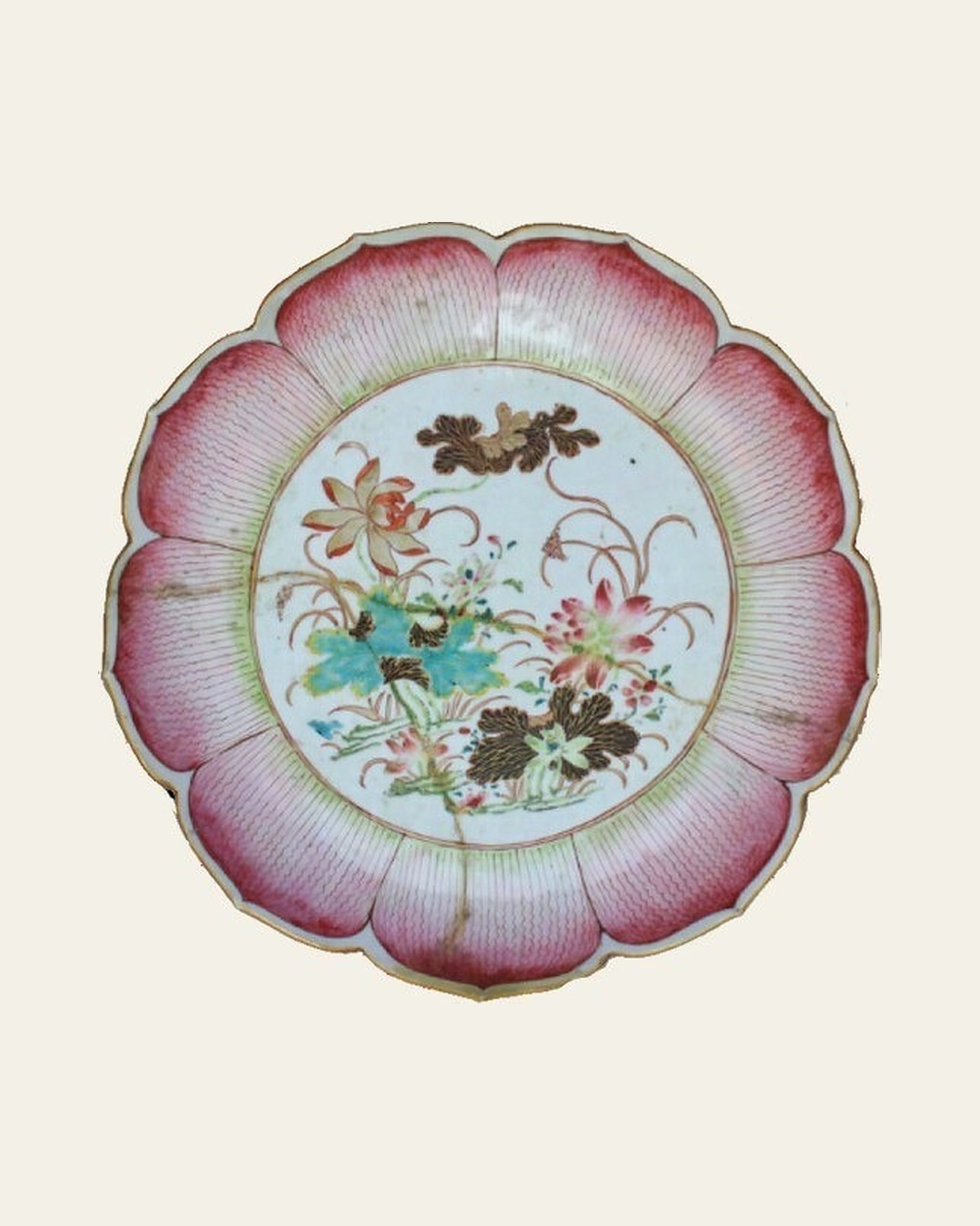 Qing dynasty famille rose porcelain dish before conservation, front, with earlier riveted repair.