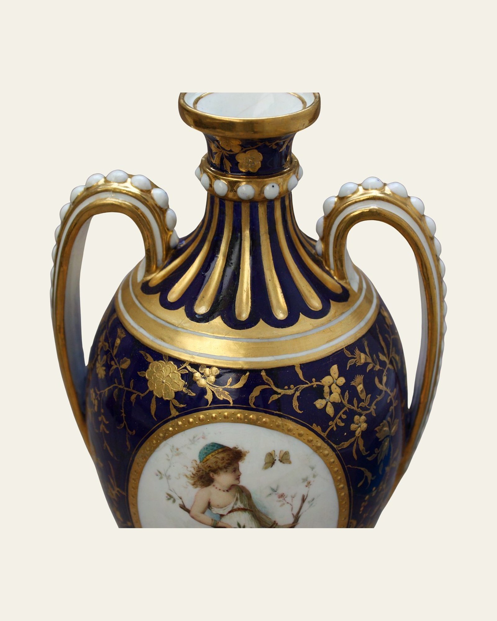 Neck and handles of the Minton porcelain urn after restoration and gilding.
