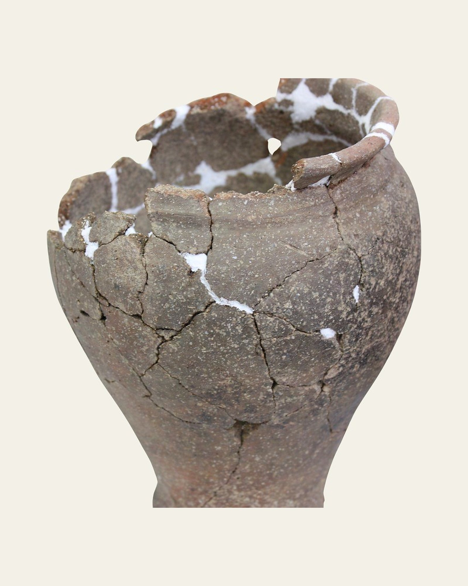 Excavated earthenware vessel after conservation treatment: stabilised and re-bonded, with visible fills.